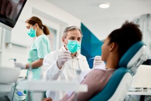 Dentist treating patient.