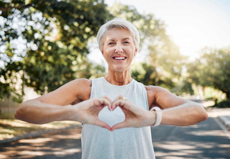 Lady makes shape of heart with her hands