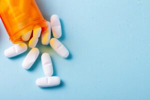 Pills spilling out of prescription bottle.